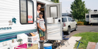  Stitt and Dante look on from their camper.