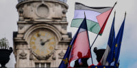 An employee places the Palestinian flag alongside other flags at the Lyon City Hall on Sept. 22, 2025, as more than 50 town halls in France flew the Palestinian flag in defiance of an interior ministry warning not to do so.