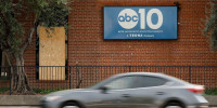 A window is was covered by a board after it was stuck by gunfire at ABC10 (KXTV) in Sacramento, Calif.,,on Sept. 19, 2025.  
