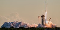 A rocket launches from a launch pad into the sky