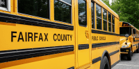 Fairfax County Public School buses idle at a middle school in Falls Church, Va.