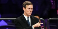 Jared Kushner points while standing