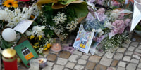 Postcards are placed among the flowers of a tribute to those that perished in the Gloria funicular, a tourist streetcar that derailed and crashed, in Lisbon, Saturday, Sept. 6, 2025.