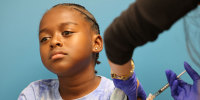 A child receives a COVID-19 vaccination in Culver City, Calif., on Sept. 23, 2025. 