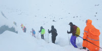 A screen capture from video shows trekkers leaving their campsite, as unusually heavy snow and rainfall pummeled the Himalayas, in the Tibet Region
