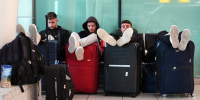 Travelers sit together and wait 