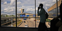 Passengers walk from a terminal at Philadelphia International Airport in Philadelphia, Tuesday, Oct. 7, 2025. 