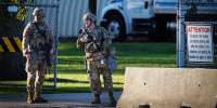 Members of the Texas National Guard stand guard at an army reserve training facility in Elwood, Ill.