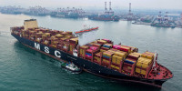 A container ship moves towards its berth at the container terminal of the port in Qingdao, in China's eastern Shandong province, on September 24, 2025. 