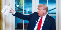 US President Donald Trump holds a model of the planned Triumph Arch.