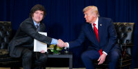 U.S. President Donald Trump (R) shakes hands with President of Argentina Javier Milei.