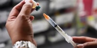 A medical assistant prepares a dose of the measles, mumps and rubella (MMR) vaccine.