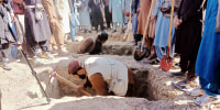 Locals dig graves for people.