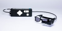 Glasses connected to a remote, laid on a white surface