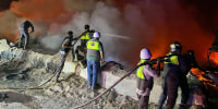 Firefighters battle blazes following a series of Israeli strikes in Ansar, southern Lebanon, on Oct. 16, 2025.