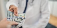 Paying medical bills with cash.