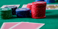 Close-up of a person showing a pair of jacks while playing poker. Poker game concept.