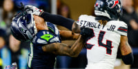 SEATTLE, WASHINGTON - OCTOBER 20: Derek Stingley Jr. #24 of the Houston Texans stiff arms the helmet off of Jaxon Smith-Njigba #11 of the Seattle Seahawks after an interception during the fourth quarter at Lumen Field on October 20, 2025 in Seattle, Washington. (Photo by Jane Gershovich/Getty Images)