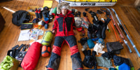 Explorer Colin O’Brady is surrounded by bags of gear for his upcoming expedition.