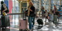 People walk through the Ronald Reagan Washington National Airport.