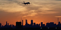 An airplane descends at O'Hare International Airport in Chicago, Wednesday, Nov. 12, 2025. 