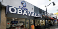 An Obamacare sign is displayed outside an insurance agency