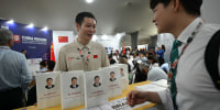 A visitor looks at Xi Jinping's book at China's Pavillion during the COP30 UN Climate Change Conference in Belem, Brazil on Nov. 10.