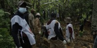 Democratic Republic of Congo Red Cross volunteers gather around coffins containing the remains of victims of an attack during a burial ceremony in Ntoyo, on September 10. 