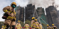 Hong Kong firefighters were scouring a still-burning apartment complex for hundreds of missing people on November 27, a day after the blaze tore through the high-rises, killing at least 44. 