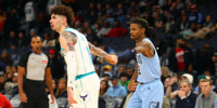 Jan 22, 2025; Memphis, Tennessee, USA; Memphis Grizzlies guard Ja Morant (right) holds the hand of Charlotte Hornets guard LaMelo Ball (left) during the fourth quarter at FedExForum. Mandatory Credit: Petre Thomas-Imagn Images