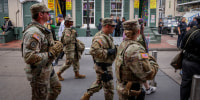 National Guardsmen patrol along Bourbon Street on Mardi Gras day in New Orleans, Louisiana