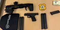 During their investigation, Officers discovered the following items in his vehicle:
• Loaded Glock .357 handgun
• Micro Conversion Kit for a Glock handgun
• Four loaded 27-round extended magazines
• Ballistic hard plate (body armor) • Binoculars, Laptop, Composition Notebook
