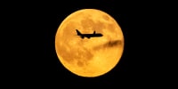 A plane passes in front of the "Beaver supermoon" on Nov. 5, 2025 over Louisville, Ky.