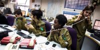 Israeli soldiers from Galei Tzahal, the Israeli army radio station, work in the newsroom at the station's studios in Jaffa
