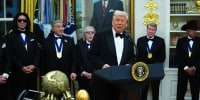President Donald Trump delivers remarks as honorees (L-R) musician Gene Simmons of the rock band KISS, actor Sylvester Stallone, musician Peter Criss of the rock band KISS, actor Michael Crawford and country musician George Strait look on during the medal presentation ceremony for the 2025 Kennedy Center Honorees in the Oval Office of the White House on December 06, 2025 in Washington, DC.