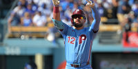 Oct 9, 2025; Los Angeles, California, USA; Philadelphia Phillies left fielder Kyle Schwarber (12) reacts after a double in the first inning against the Los Angeles Dodgers during game four of the NLDS round for the 2025 MLB playoffs at Dodger Stadium. Mandatory Credit: Jayne Kamin-Oncea-Imagn Images