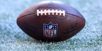Dec 7, 2025; Glendale, Arizona, USA; Detailed view of the NFL shield logo on an official Wilson football during the Arizona Cardinals game against the Los Angeles Rams at State Farm Stadium. Mandatory Credit: Mark J. Rebilas-Imagn Images
