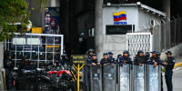 Image: Security forces stand guard at the entrance of the El Helicoide