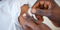 Shot of an unrecognizable doctor applying a cotton ball to a patient's arm at a hospital