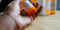 Woman Holds Bottle of Prescription Medication