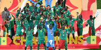 Senegal's forward #10 Sadio Mane holds up the trophy as he celebrates with his teammates after winning the Africa Cup of Nations final against Morocco at the Prince Moulay Abdellah Stadium in Rabat on January 18, 2026. (Photo by SEBASTIEN BOZON / AFP via Getty Images)