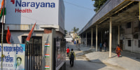 Narayana Multispeciality Hospital entrance where people are seen walking to. 