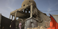 A child stands next to the al-Albani Mosque, destroyed during Israeli military strikes, in Khan Yunis, southern Gaza Strip on January 30.
