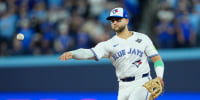 Nov 1, 2025; Toronto, Ontario, CAN; Toronto Blue Jays designated hitter Bo Bichette (11) throws to first for an out against Los Angeles Dodgers second baseman Tommy Edman (25) in the eighth inning during game seven of the 2025 MLB World Series at Rogers Centre. Mandatory Credit: John E. Sokolowski-Imagn Images