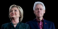 Hillary Clinton, left, and Bill Clinton stand next to each other