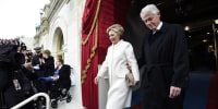 Hillary Clinton and Bill Clinton walk out of a building together