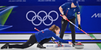 Britain's Jennifer Dodds curls the stone past Britain's Bruce Mouat 