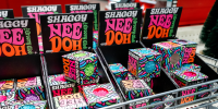 Neon lettering on several display boxes reads SHAGGY NEEDOH THE GROOVY GLOB.