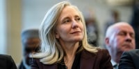 Abigail Spanberger smiles as she looks over her left shoulder.