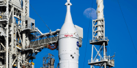 A spacecraft is docked on a launcher outside